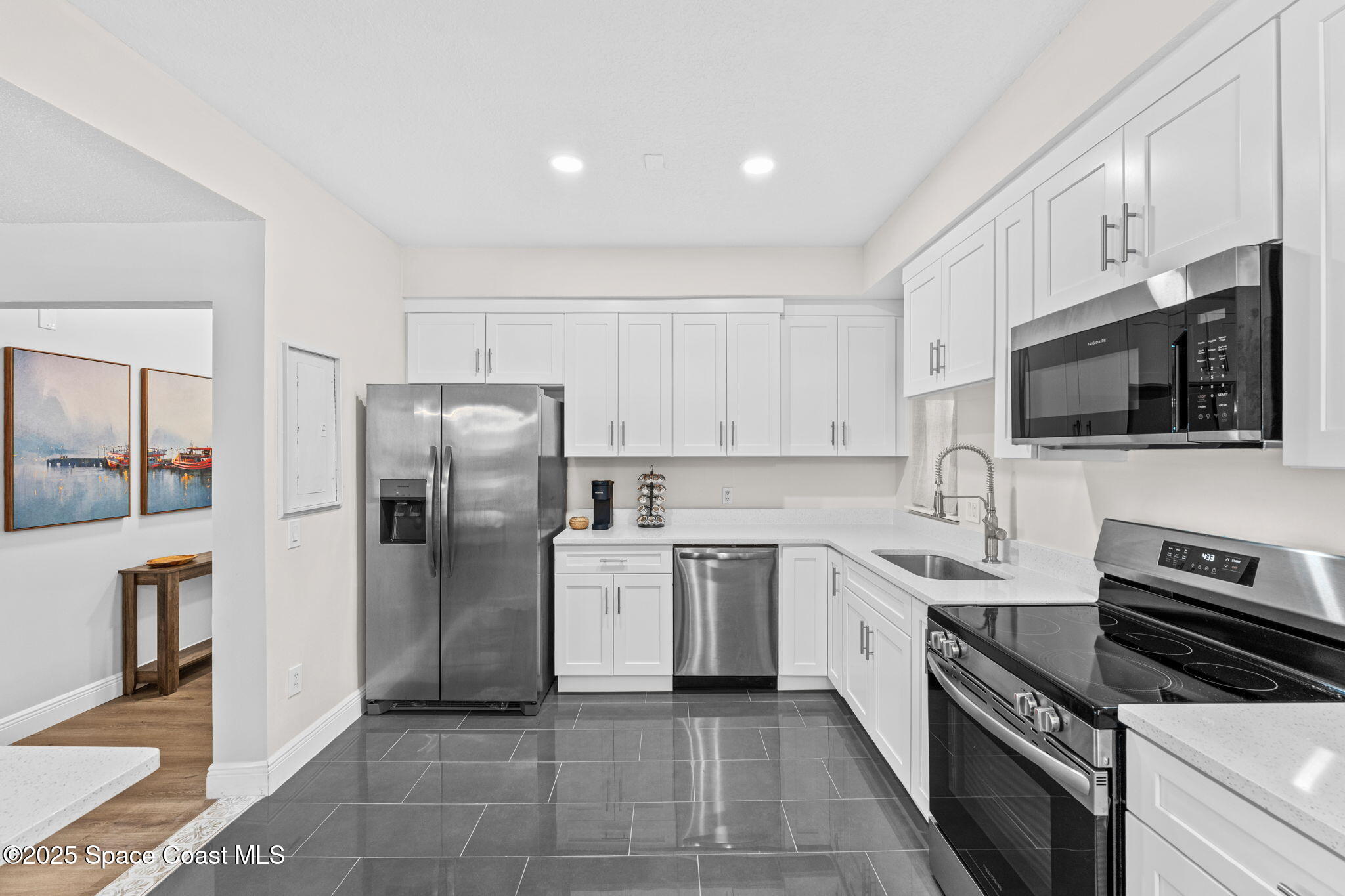 3037 S Highway, Unit 3C Melbourne Beach, FL 32951 - Photo 14 of 52 a kitchen with stainless steel appliances a refrigerator sink and microwave