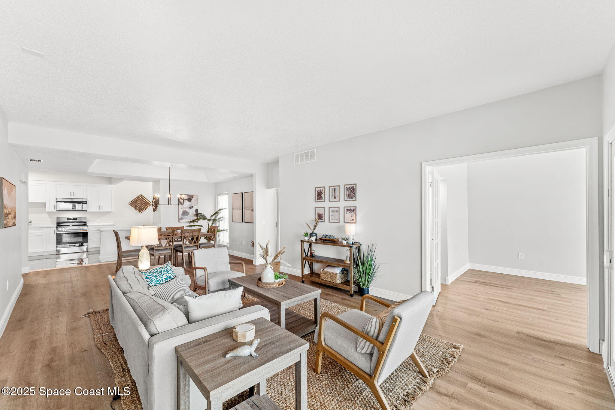 3037 S Highway, Unit 3C Melbourne Beach, FL 32951 - Photo 19 of 52 a living room with furniture and a wooden floor
