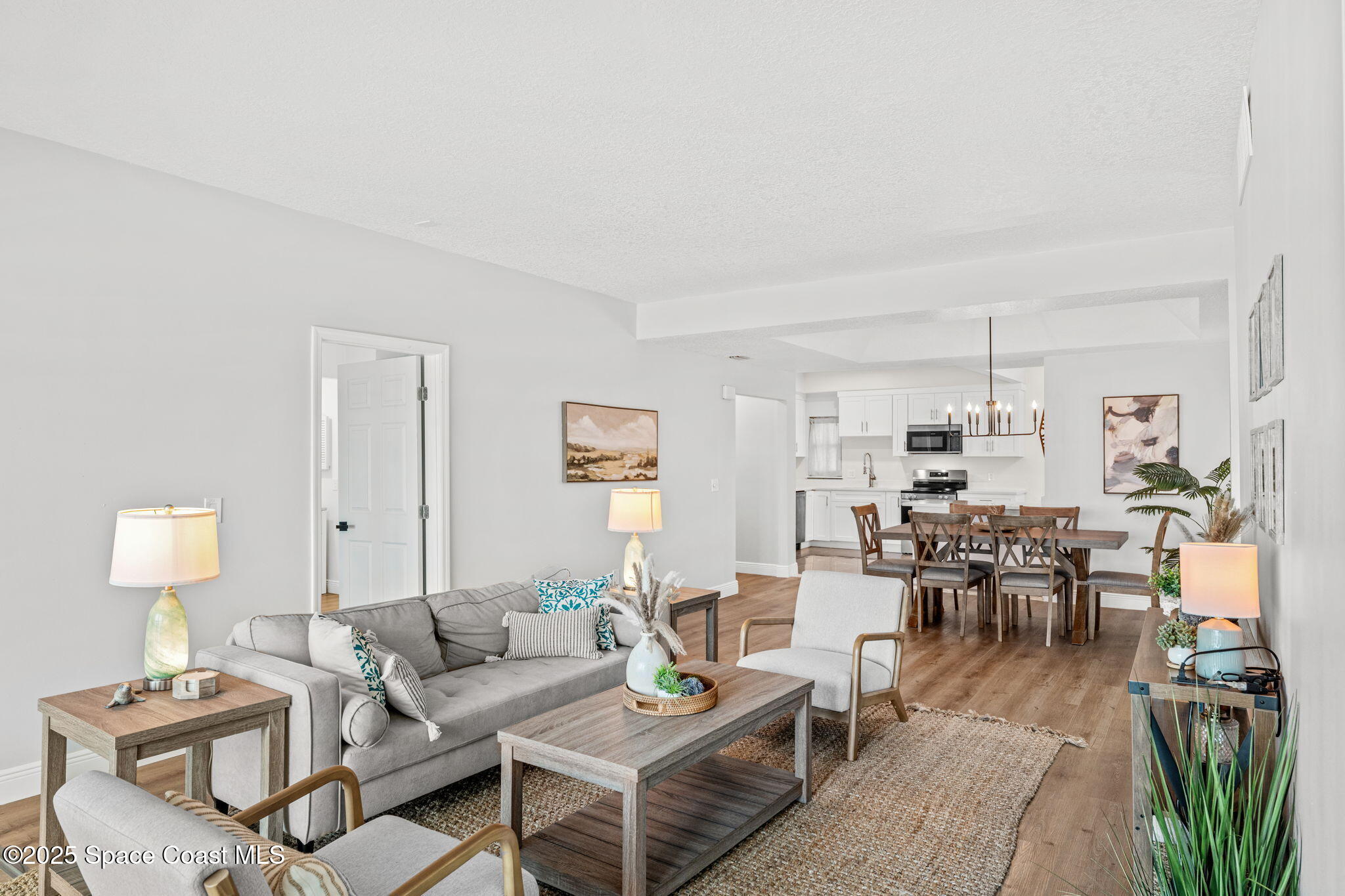 3037 S Highway, Unit 3C Melbourne Beach, FL 32951 - Photo 20 of 52 a living room with furniture and wooden floor