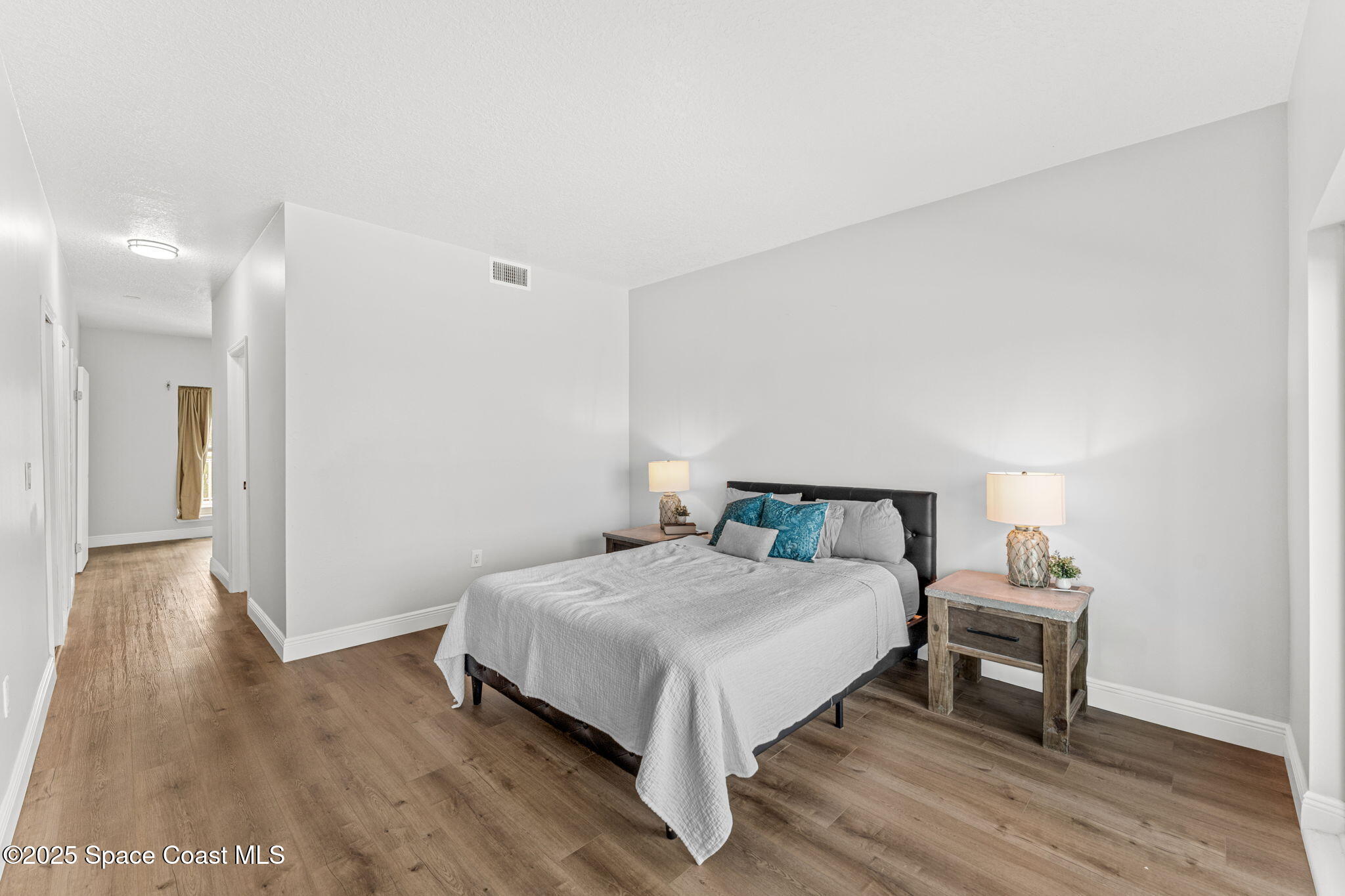 3037 S Highway, Unit 3C Melbourne Beach, FL 32951 - Photo 21 of 52 a bedroom with a bed and a table