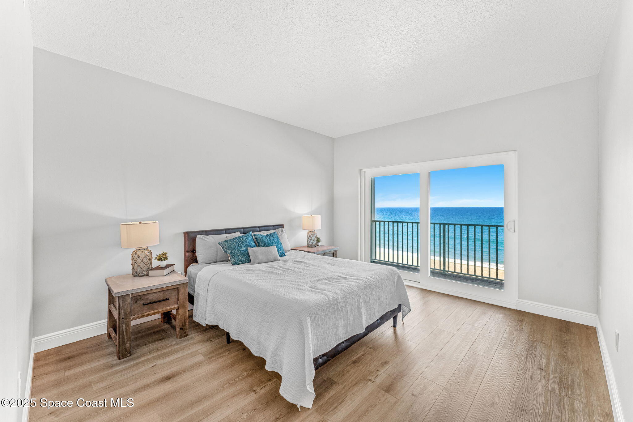 3037 S Highway, Unit 3C Melbourne Beach, FL 32951 - Photo 22 of 52 a bedroom with a bed and a large window