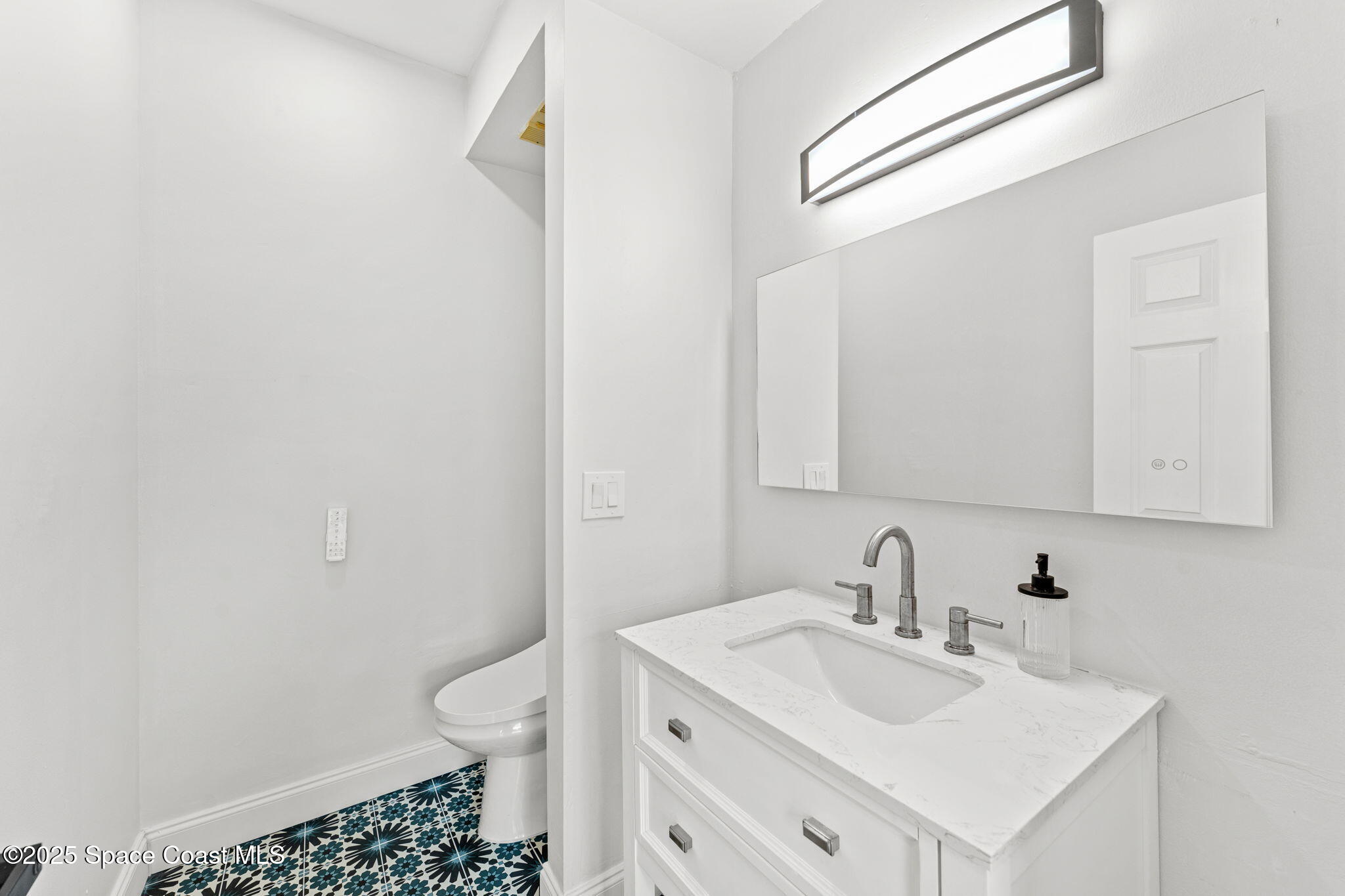 3037 S Highway, Unit 3C Melbourne Beach, FL 32951 - Photo 30 of 52 a bathroom with a sink toilet and vanity