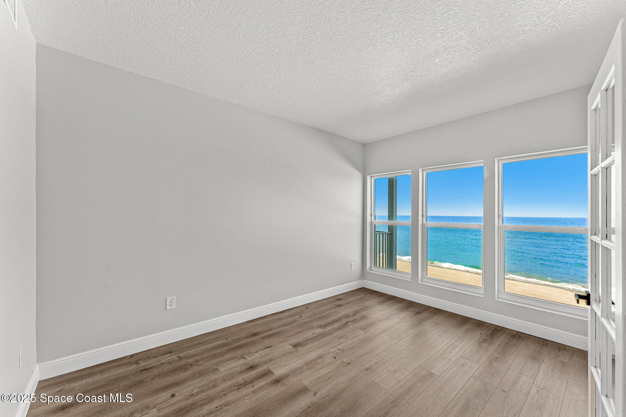 3037 S Highway, Unit 3C Melbourne Beach, FL 32951 - Photo 32 of 52 a view of an empty room with wooden floor