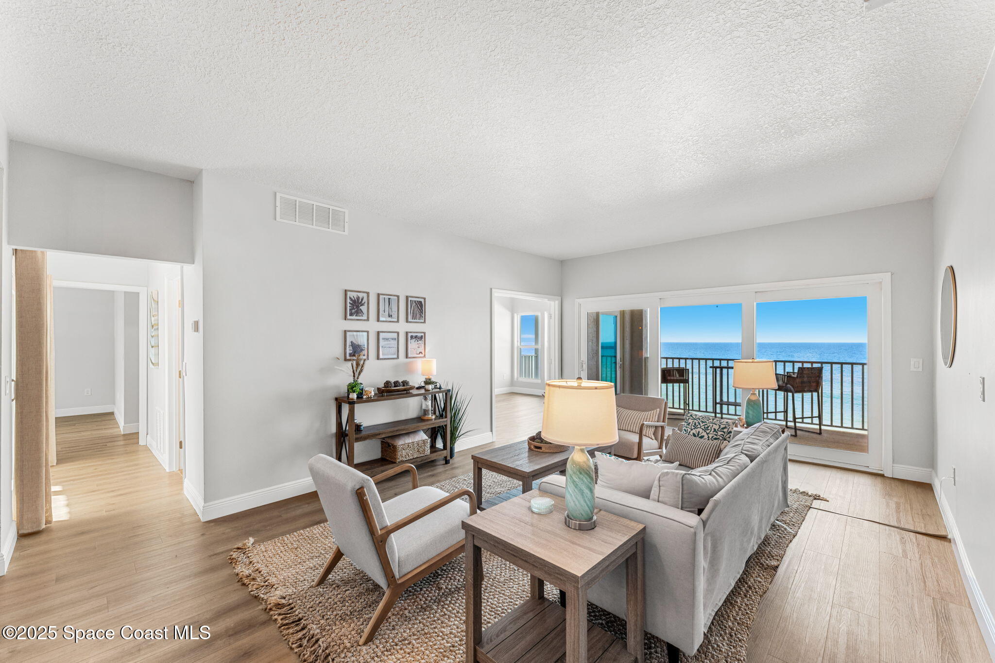 3037 S Highway, Unit 3C Melbourne Beach, FL 32951 - Photo 10 of 52 a living room with furniture and a wooden floor