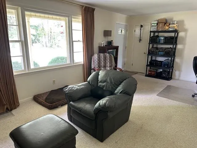 a living room with furniture window and wooden floor