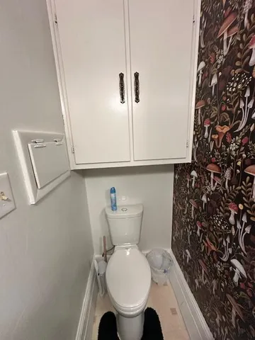 a bathroom with a toilet and a shower