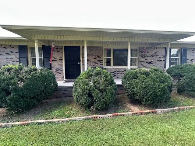a kitchen with a stove a table and chairs in it