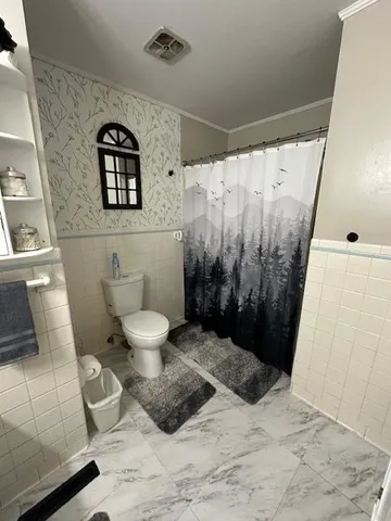 a bedroom with a bed and dresser