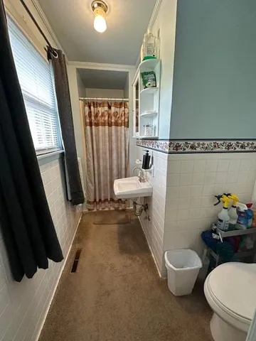 a bedroom with a bed and wall painting with a window