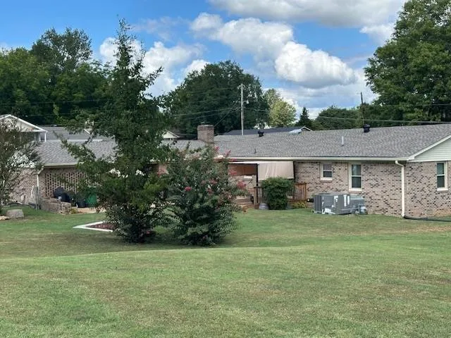 a view of a house with a yard and a street