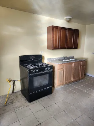 a kitchen with granite countertop a stove and a sink