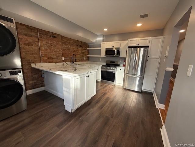 1 South Hamilton Street, Unit 3 Poughkeepsie, NY 12601 - Photo 4 of 17 a kitchen with stainless steel appliances wooden floors and wooden cabinets