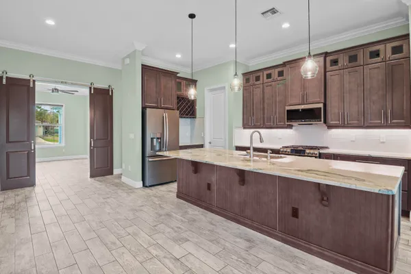 a kitchen with stainless steel appliances granite countertop a stove and a sink