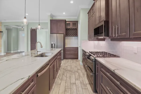a kitchen with a sink and a refrigerator