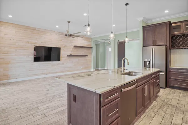 a bathroom with a sink a large mirror and a shower