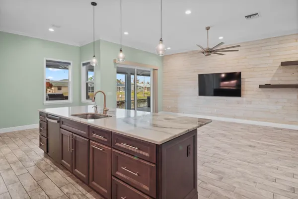 a kitchen with stainless steel appliances granite countertop a sink a stove and a refrigerator