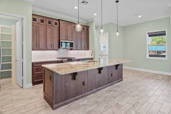 a kitchen with a sink stove and cabinets
