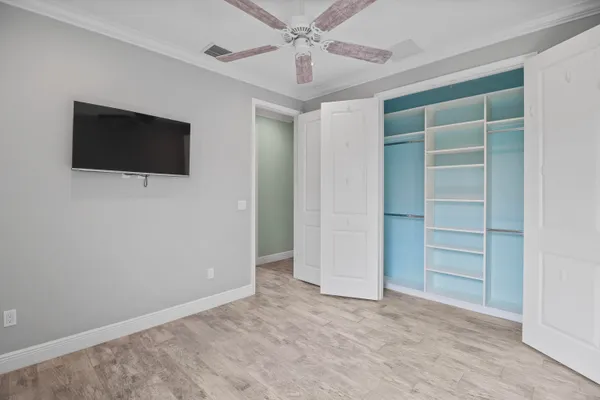 an empty room with closet and entryway