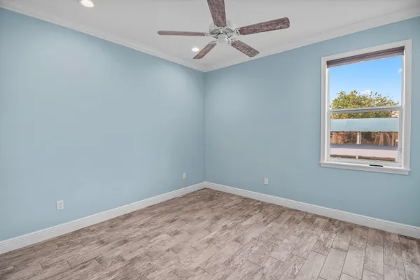 a bathroom with a granite countertop sink a toilet and a mirror