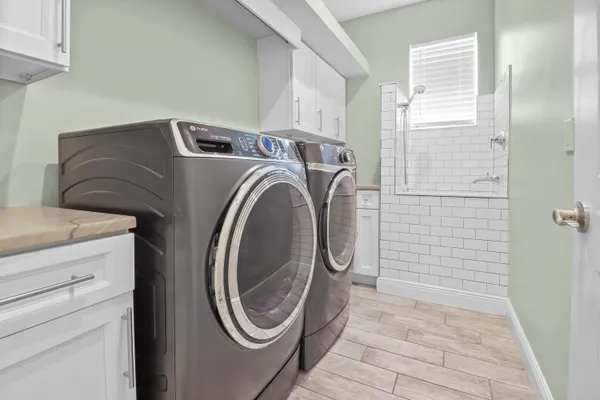 an empty room with fan and windows