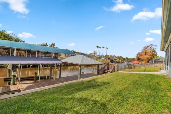 an aerial view of a house with swimming pool and a yard