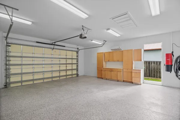 an aerial view of residential houses with outdoor space and lake view