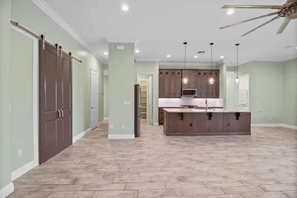 a large room with lots of counter space and windows