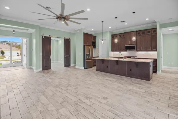a large kitchen with stainless steel appliances granite countertop a sink and a stove