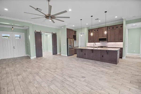a bathroom with a granite countertop sink a large mirror and a shower