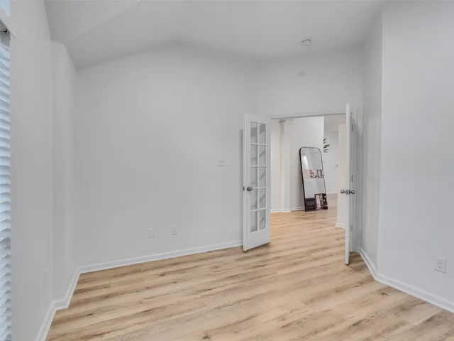 a view of a room with wooden floor