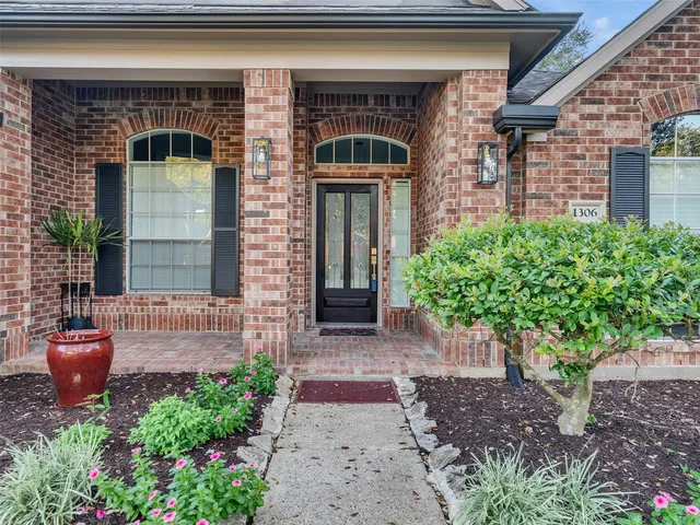 a front view of a house with potted plants