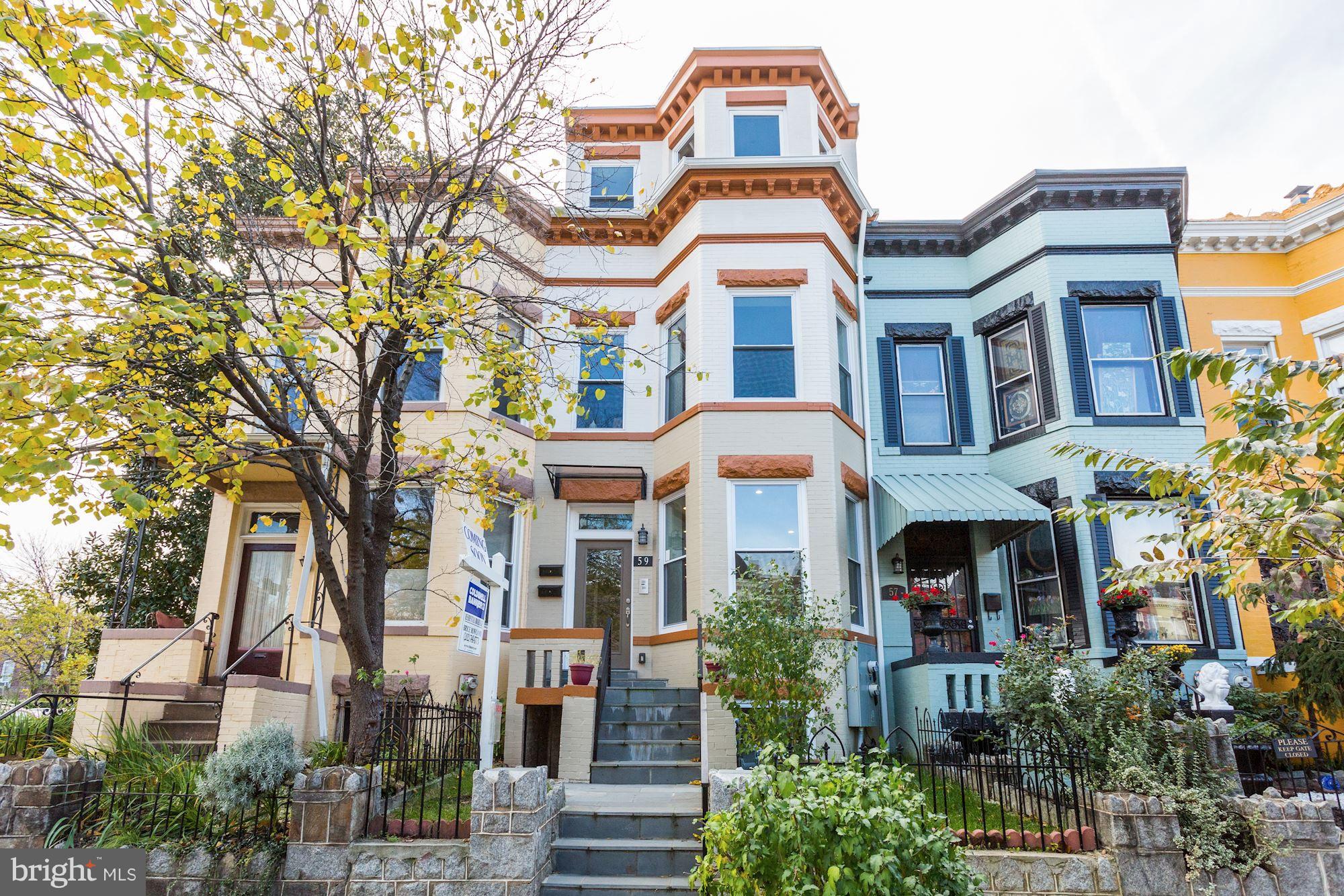 front view of a brick house with a yard