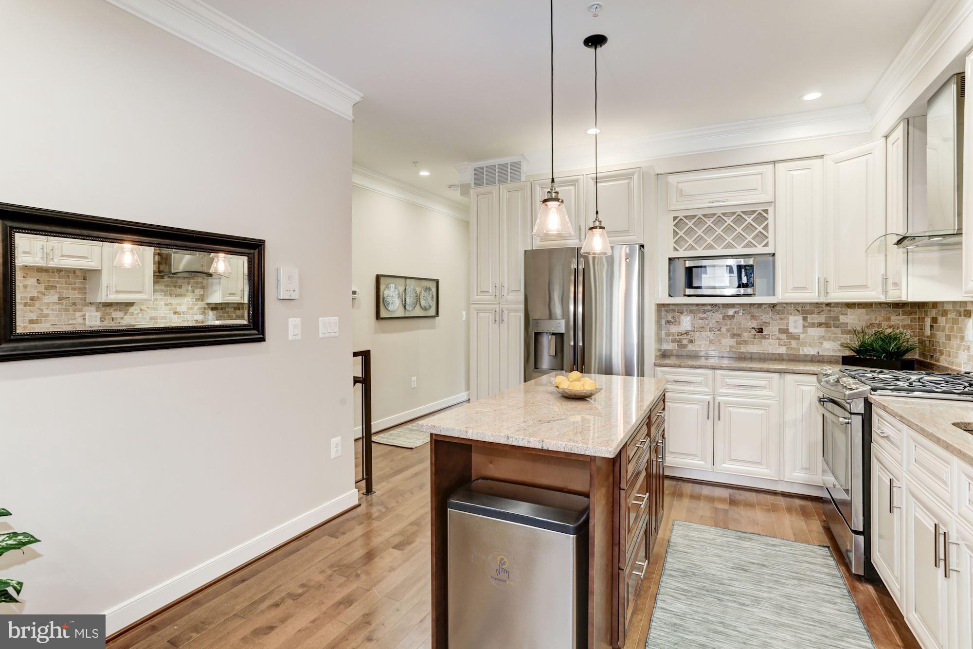 59 R Street Northeast, Unit 1 Washington, DC 20002 - Photo 11 of 40 a kitchen with a refrigerator a sink and wooden floor