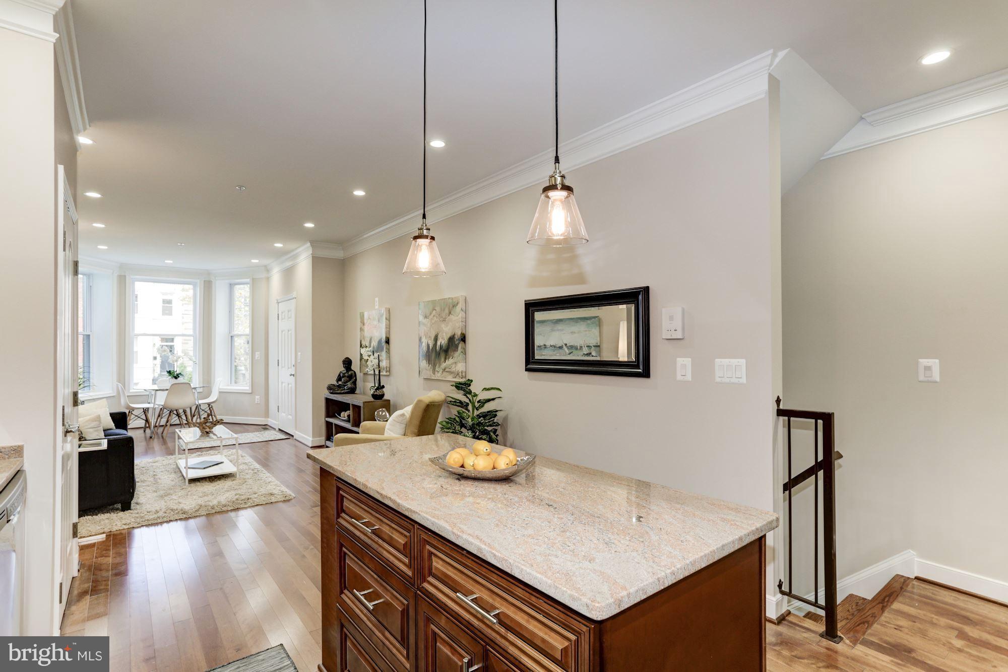 59 R Street Northeast, Unit 1 Washington, DC 20002 - Photo 15 of 40 a living room with stainless steel appliances kitchen island granite countertop furniture and a view of living room