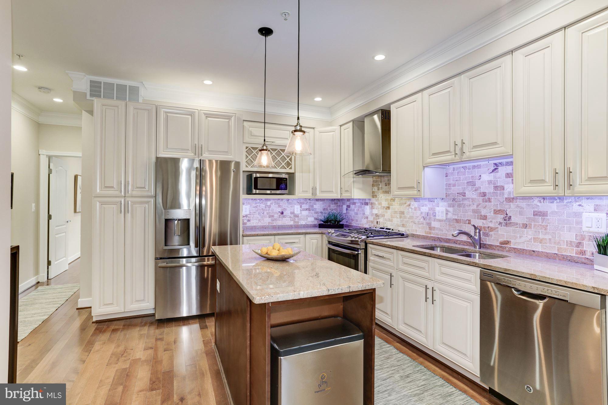 59 R Street Northeast, Unit 1 Washington, DC 20002 - Photo 16 of 40 a kitchen with stainless steel appliances a sink stove and refrigerator