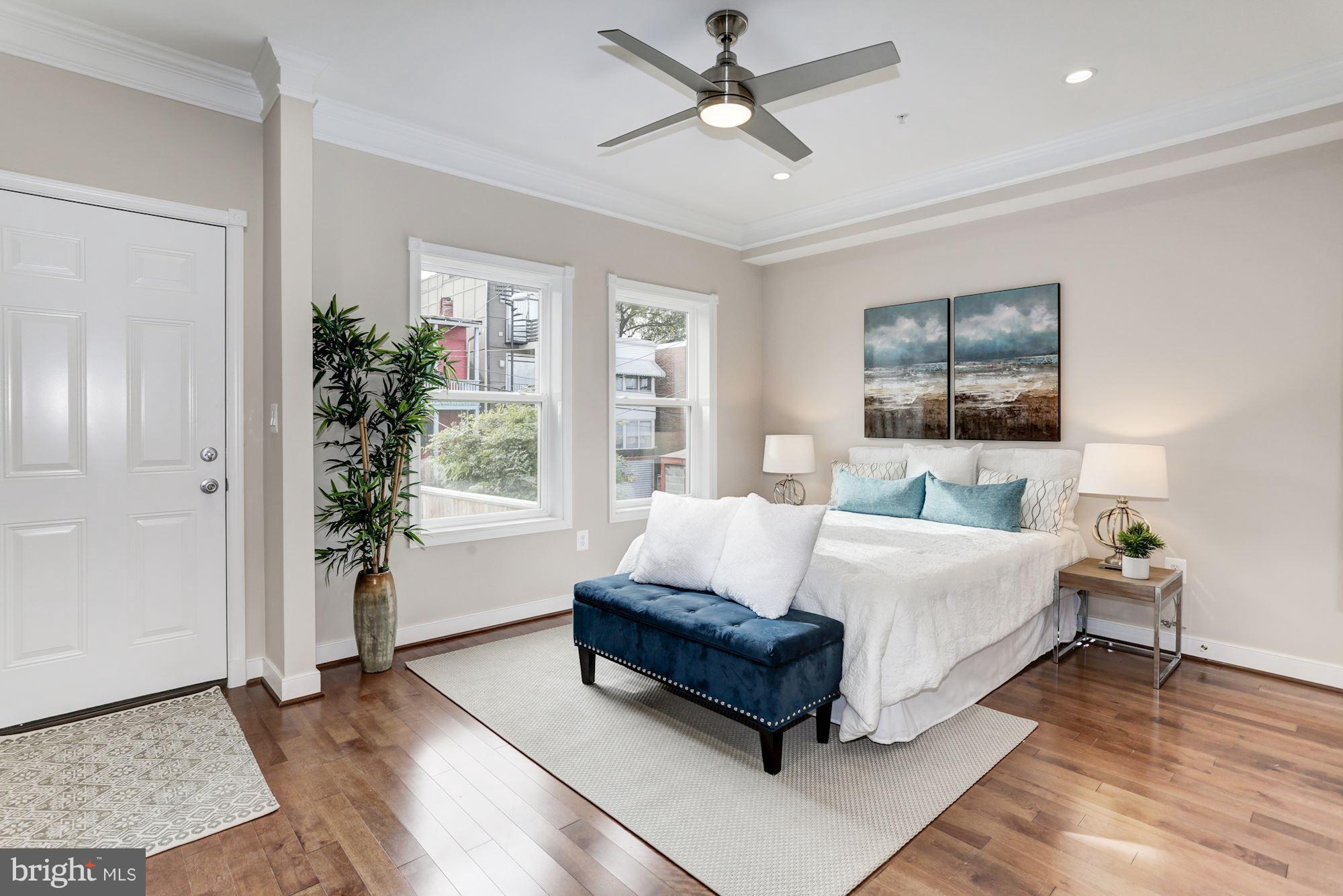 59 R Street Northeast, Unit 1 Washington, DC 20002 - Photo 19 of 40 a living room with a bed furniture and a window