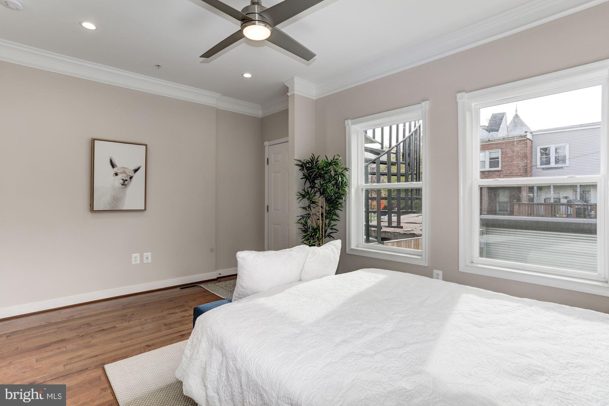 59 R Street Northeast, Unit 1 Washington, DC 20002 - Photo 20 of 40 a bedroom with a large bed and a window