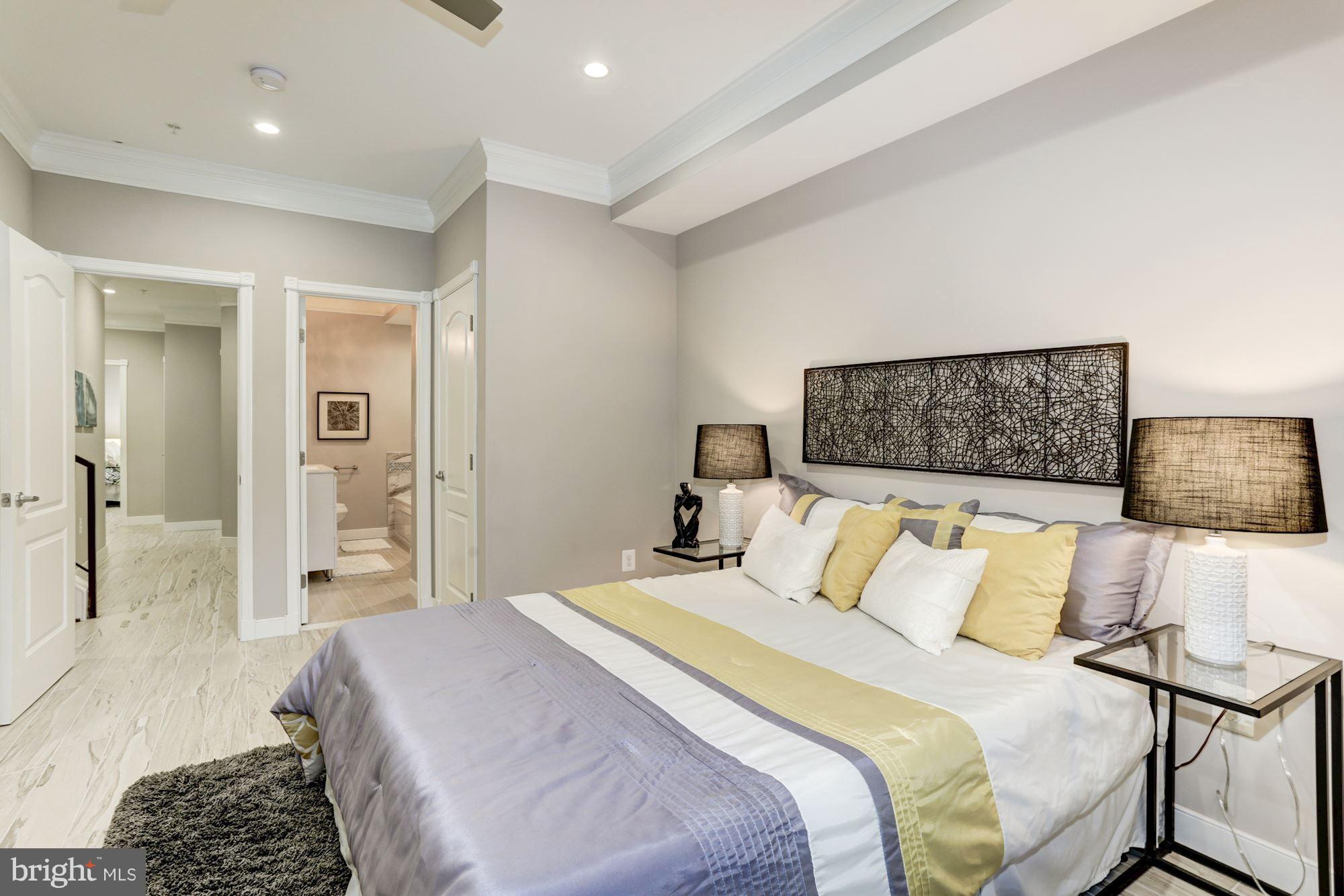 59 R Street Northeast, Unit 1 Washington, DC 20002 - Photo 24 of 40 a bedroom with a bed and walk in closet