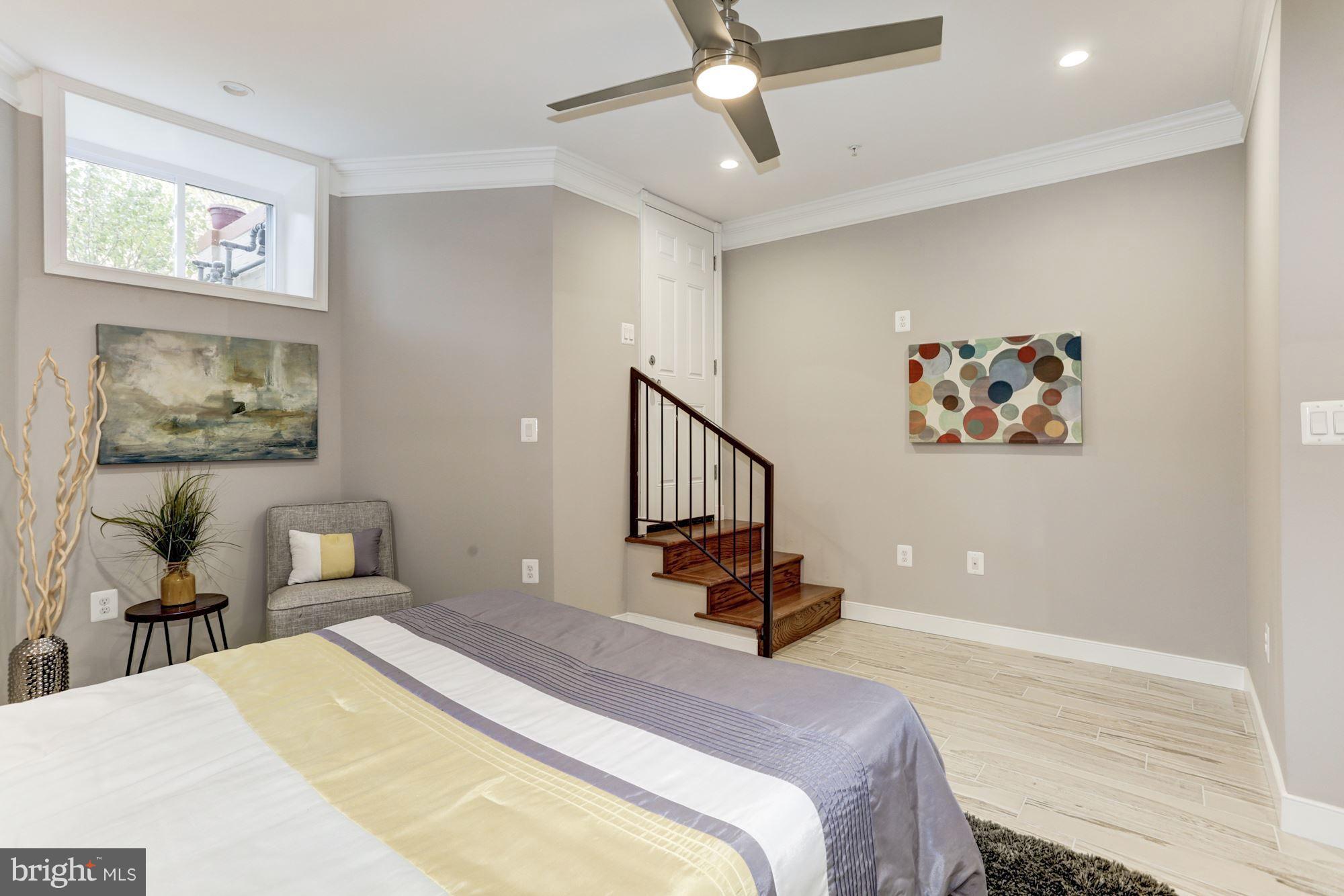 59 R Street Northeast, Unit 1 Washington, DC 20002 - Photo 26 of 40 a bedroom with a bed and a chandelier