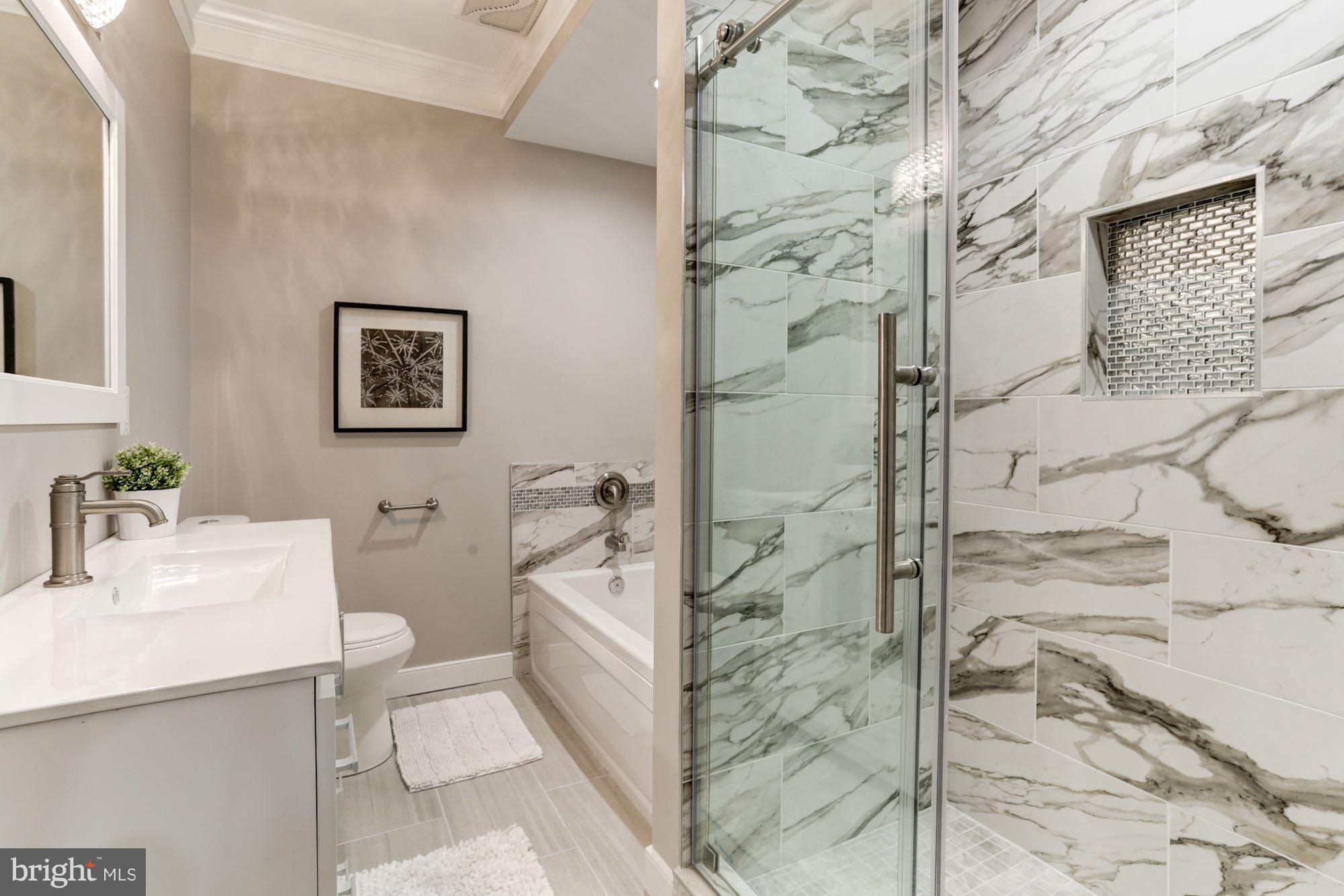 59 R Street Northeast, Unit 1 Washington, DC 20002 - Photo 28 of 40 a bathroom with a sink toilet and shower