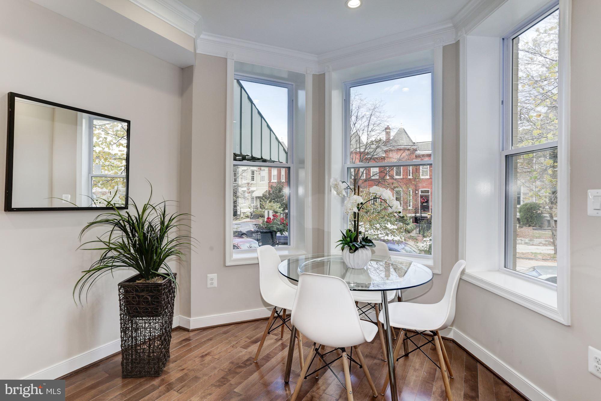 59 R Street Northeast, Unit 1 Washington, DC 20002 - Photo 4 of 40 a view of a dining room with furniture window and wooden floor