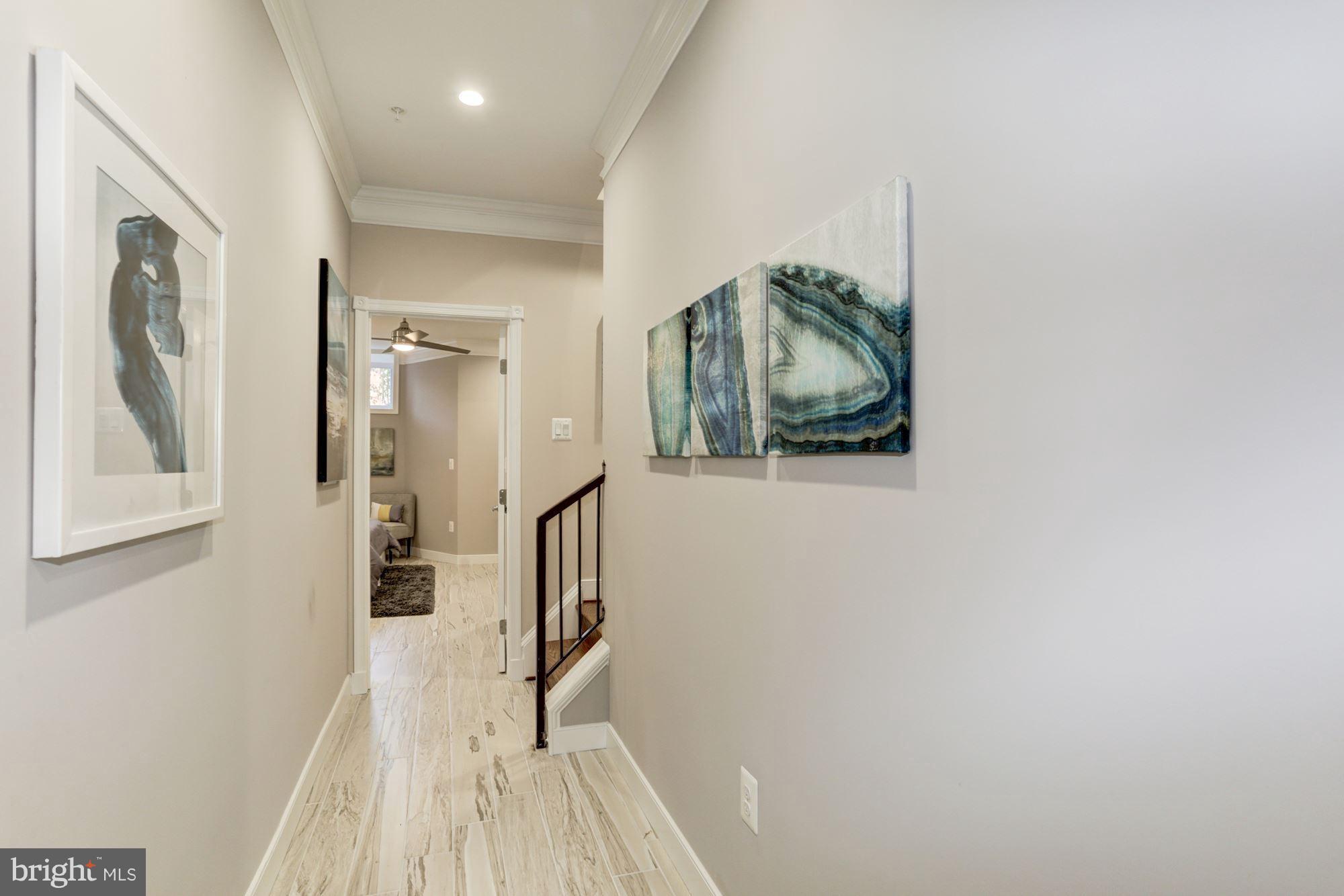 59 R Street Northeast, Unit 1 Washington, DC 20002 - Photo 32 of 40 a view of a hallway with wooden floor and staircase