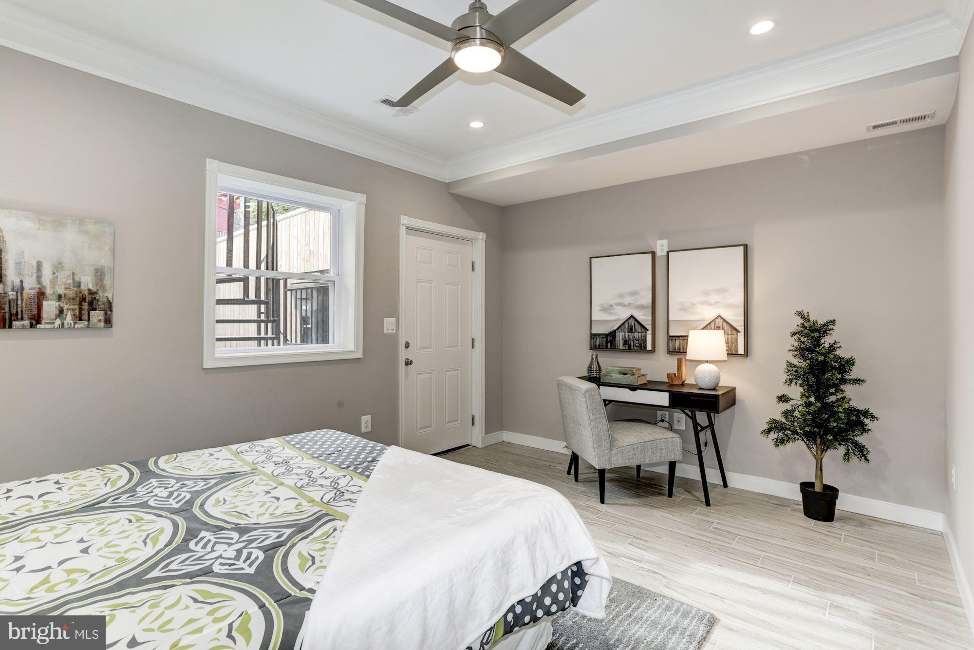 59 R Street Northeast, Unit 1 Washington, DC 20002 - Photo 34 of 40 a bedroom with a bed and a chandelier