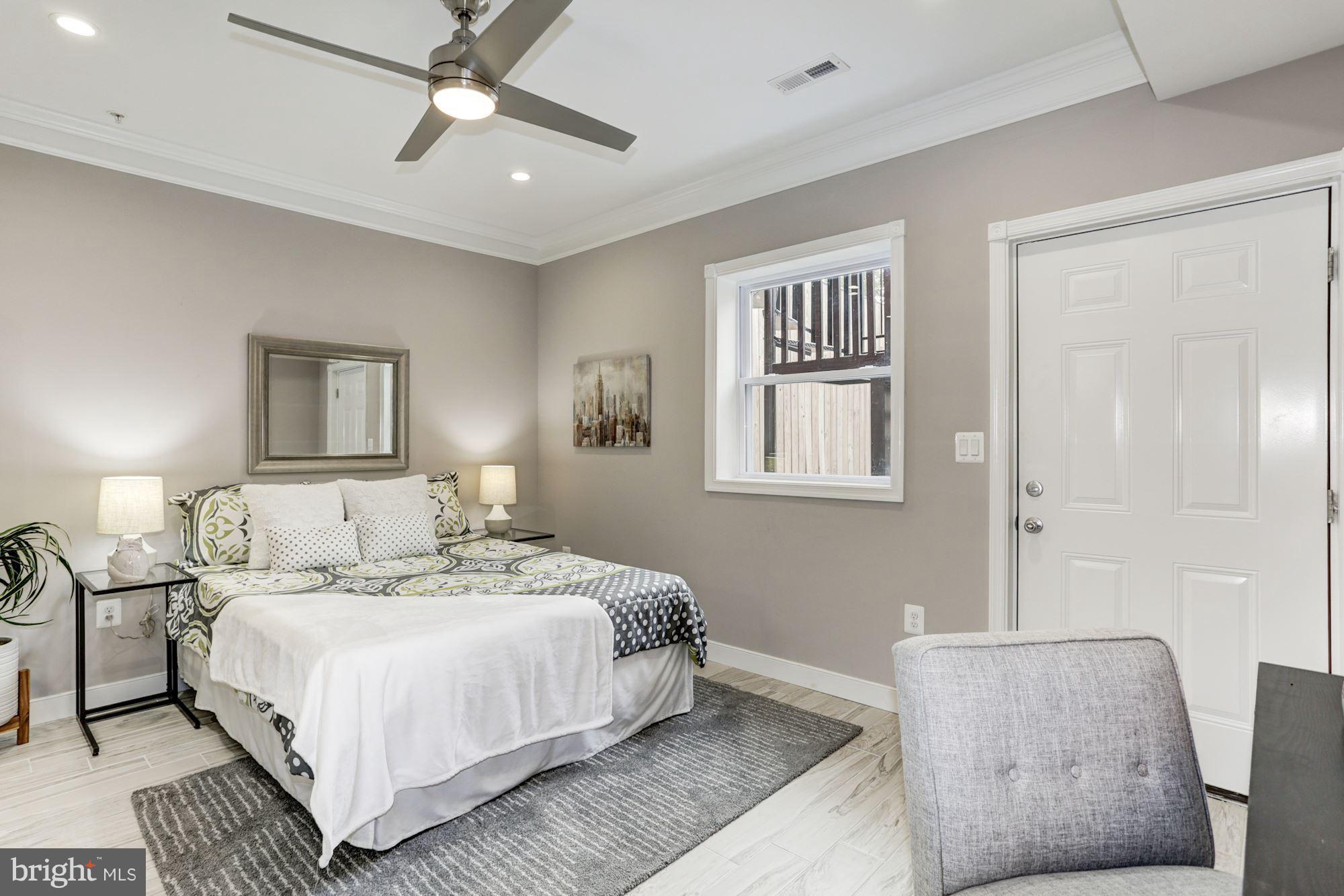 59 R Street Northeast, Unit 1 Washington, DC 20002 - Photo 35 of 40 a bedroom with a large bed and a couch