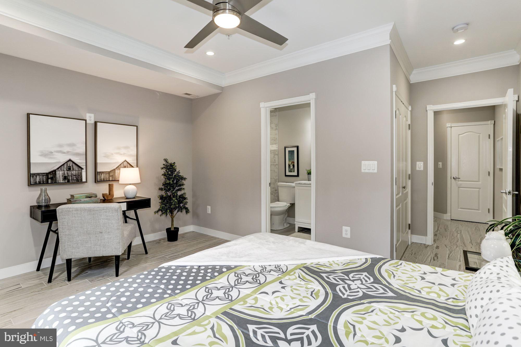 59 R Street Northeast, Unit 1 Washington, DC 20002 - Photo 37 of 40 a bedroom with a bed and a chandelier