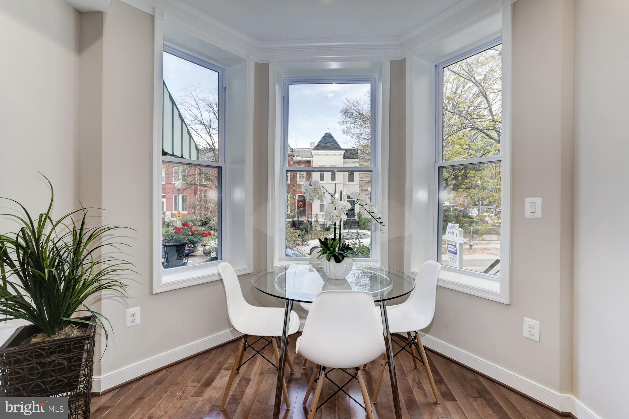 59 R Street Northeast, Unit 1 Washington, DC 20002 - Photo 5 of 40 a view of a dining room with furniture window and wooden floor