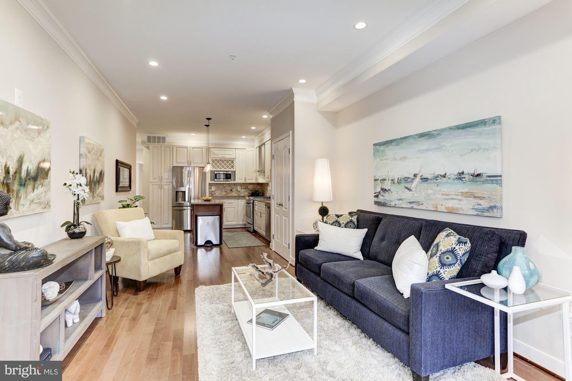 59 R Street Northeast, Unit 1 Washington, DC 20002 - Photo 7 of 40 a living room with furniture and a painting