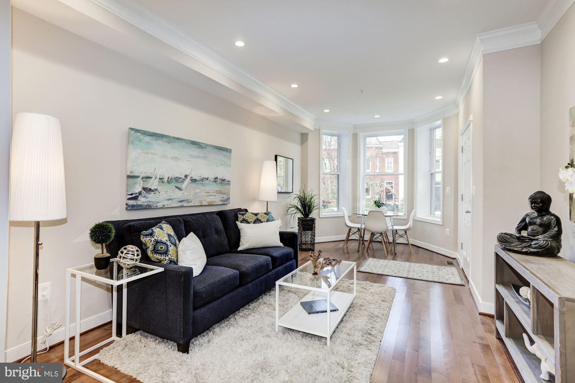 59 R Street Northeast, Unit 1 Washington, DC 20002 - Photo 8 of 40 a living room with furniture and wooden floor