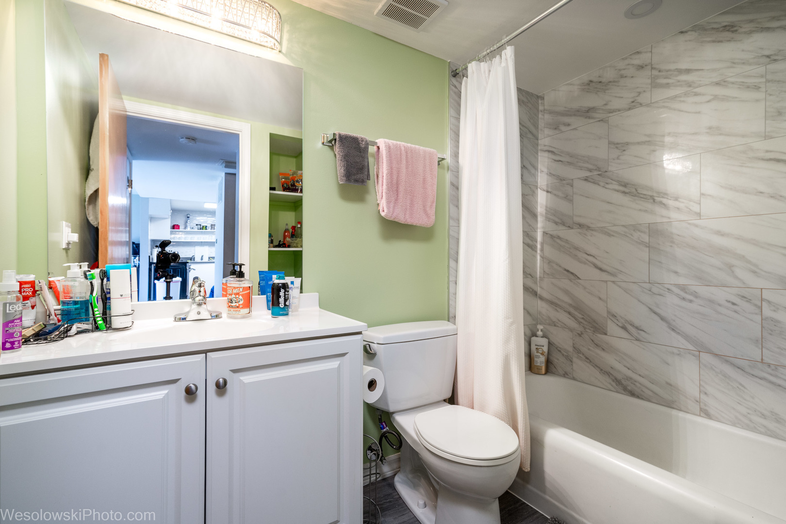 127 North Wolf Road, Unit 59A Wheeling, IL 60090 - Photo 3 of 17 a bathroom with a sink mirror vanity and toilet