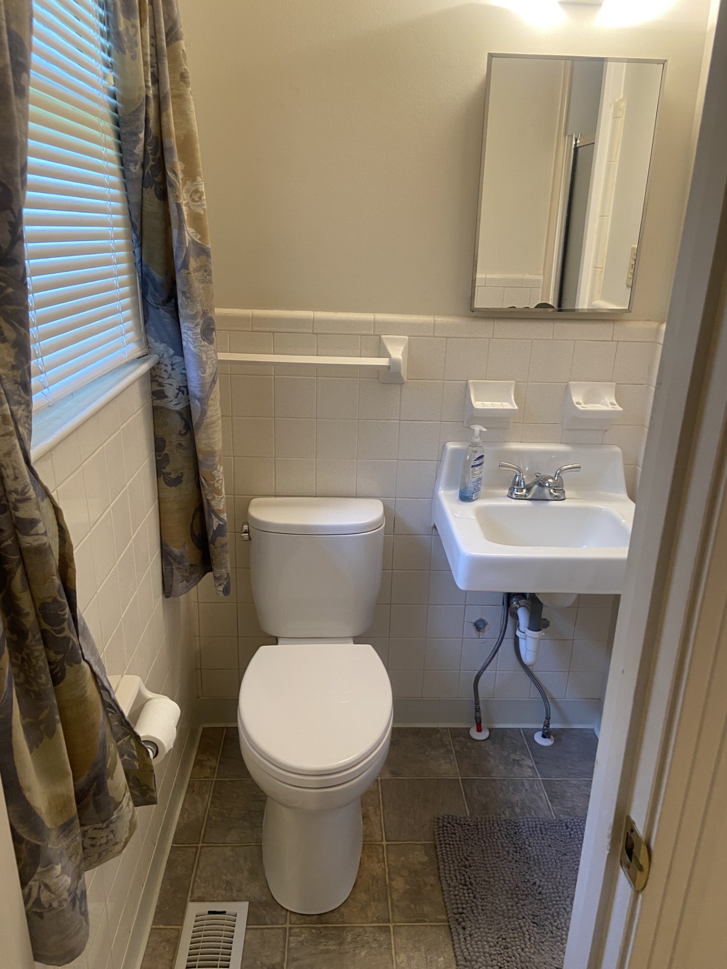 2169 Post Road Clarksville, TN 37043 - Photo 10 of 14 a white toilet sitting next to a bathroom sink